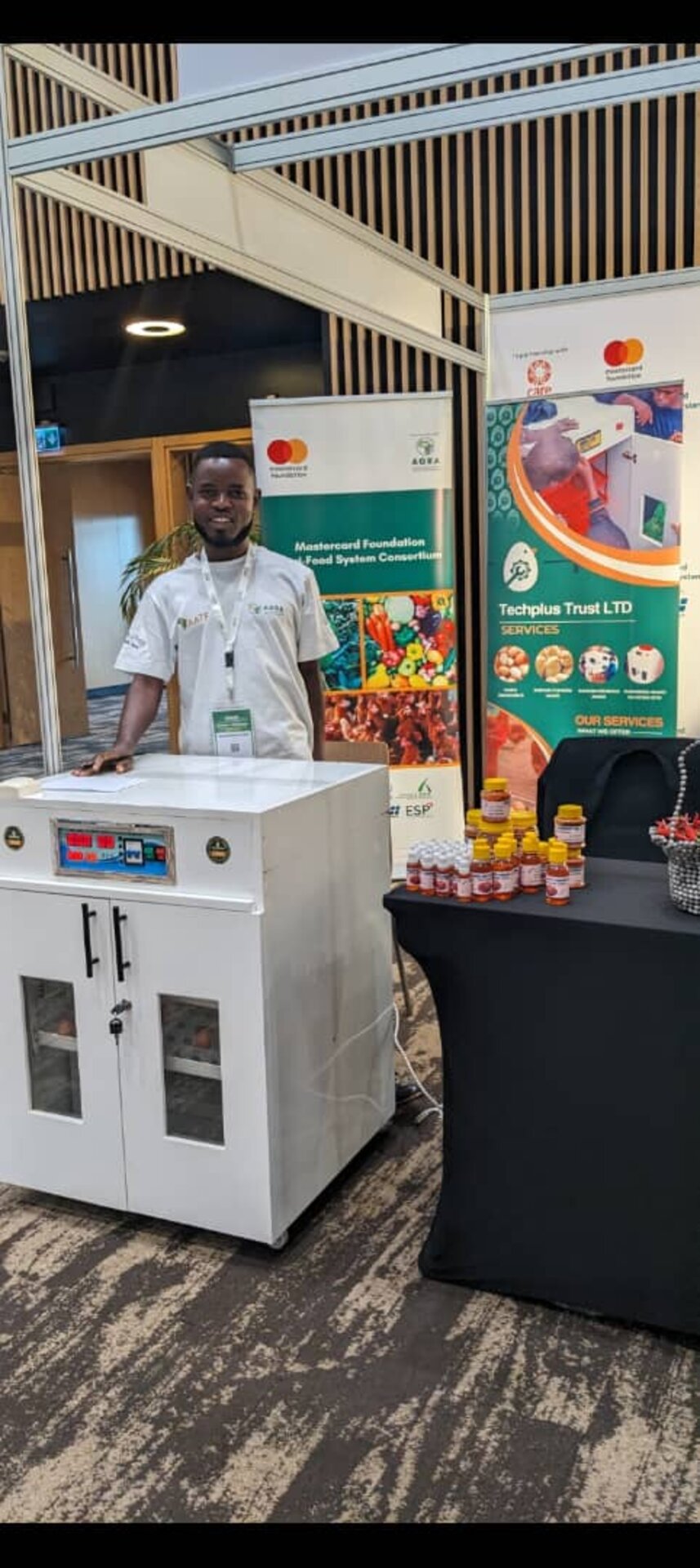 A TechPlus Trust team member with an incubator at a partner exhibition